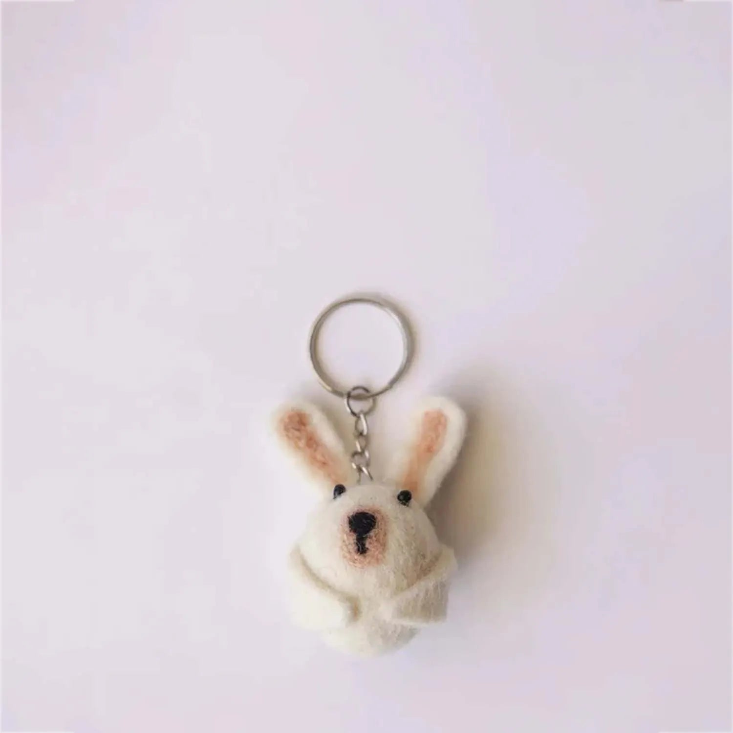 "Abeer the Rabbit, a soft, adorable stuffed toy with gray fur, a light blue outfit, and a charming bow tie, designed for children and collectors."