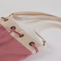 Ria Bucket Bag with sleek cotton canvas material and adjustable metal hardware