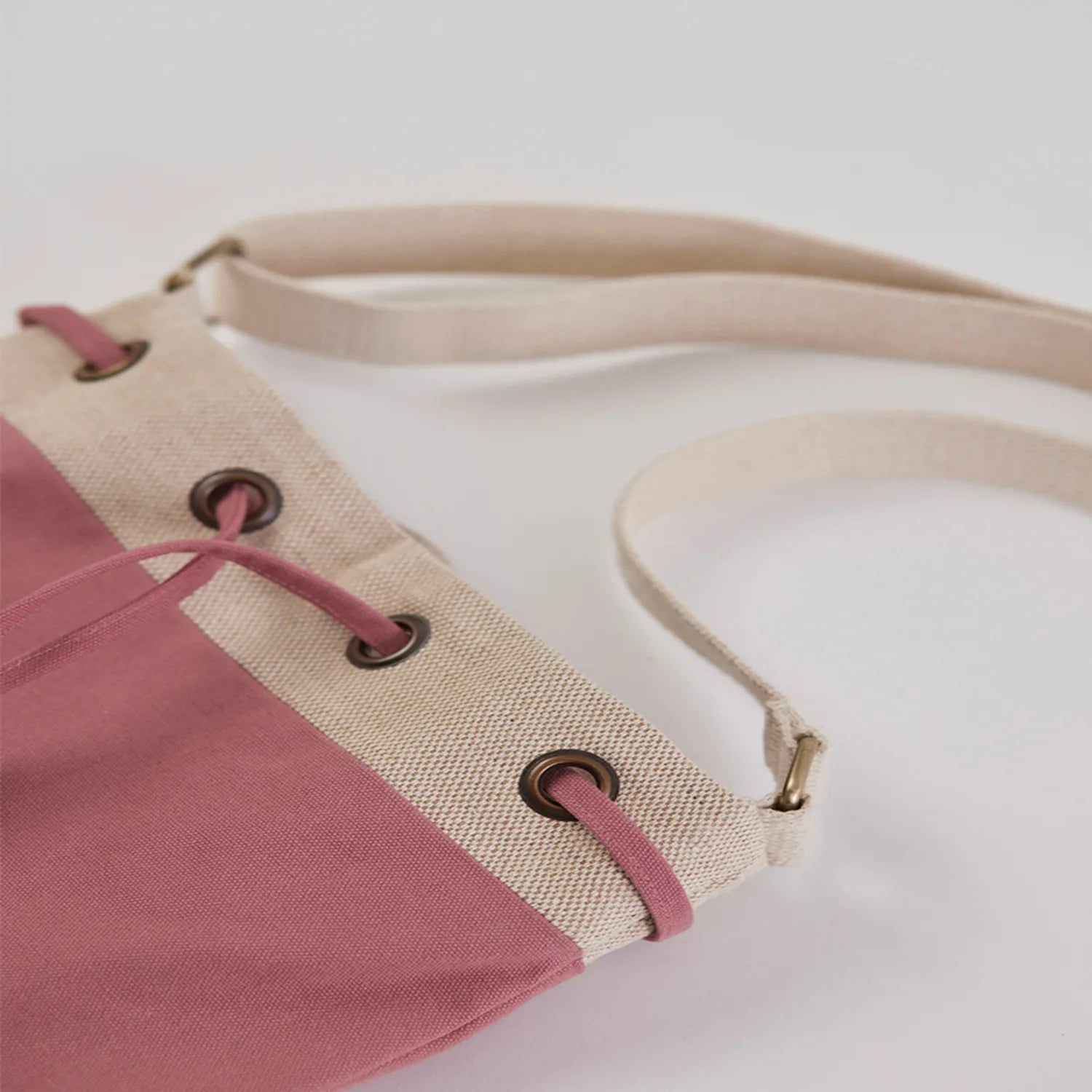 Ria Bucket Bag with sleek cotton canvas material and adjustable metal hardware