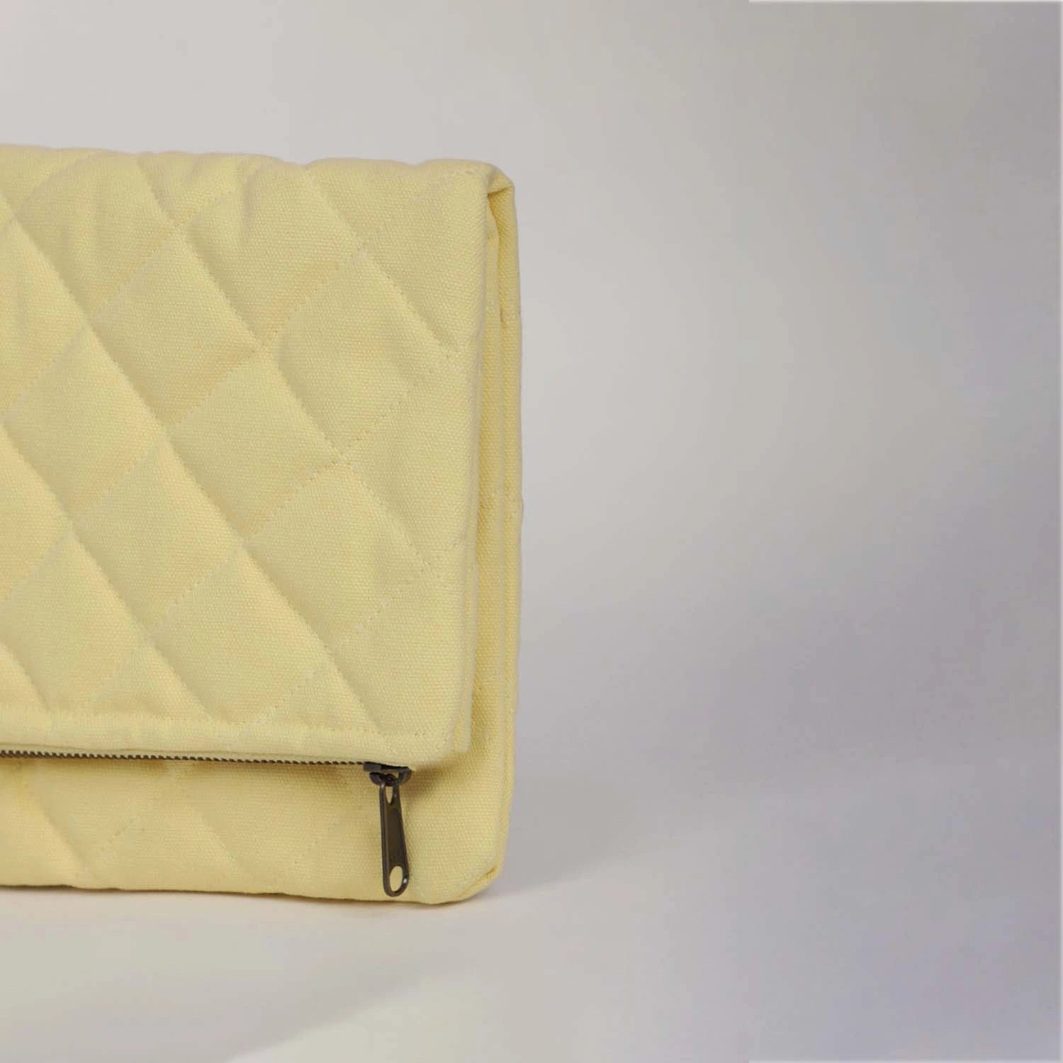 Handcrafted cotton canvas, our Krista Foldable Quilted Natural Clutch