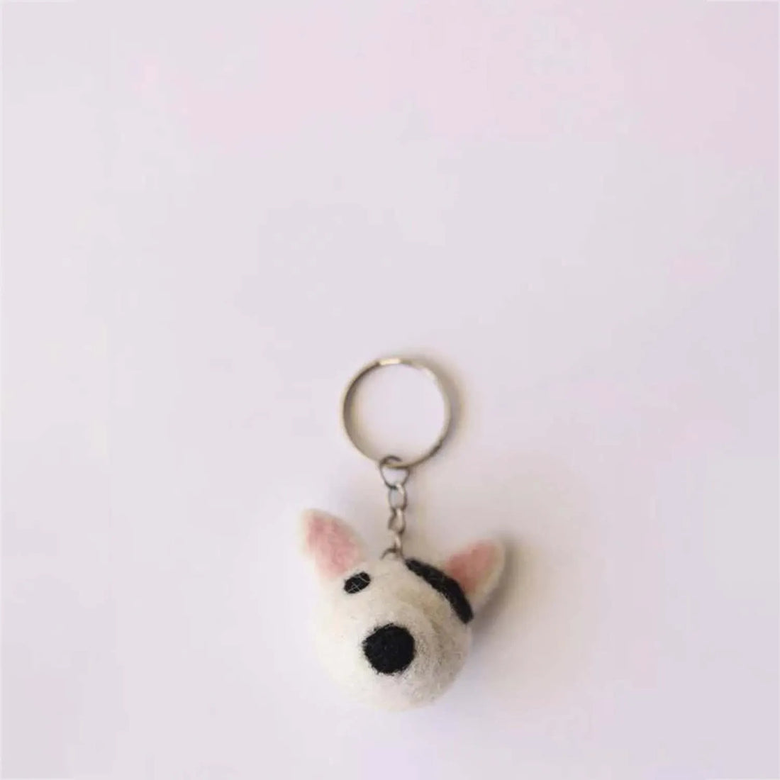 Compact K-9 dog keychain with realistic features including a tail and paws ideal for attaching to bags or keys
