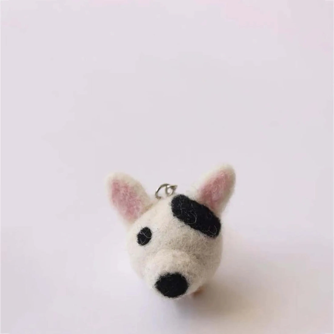 Compact K-9 dog keychain with realistic features including a tail and paws ideal for attaching to bags or keys
