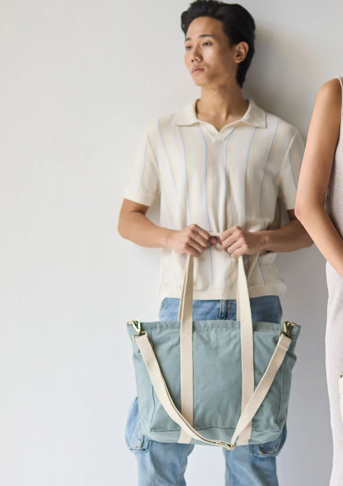 "Sun J Bag Medium resting on a wooden table with vibrant accessories around it."
